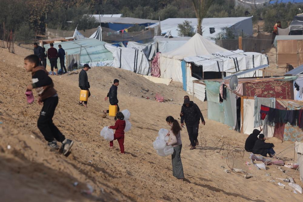 Des Palestiniens déplacés transportent des bouteilles vides vers un camion d'eau de MSF à Tal Al-Sultan, un quartier du sud de la ville de Gaza. ©Mohammed Abed