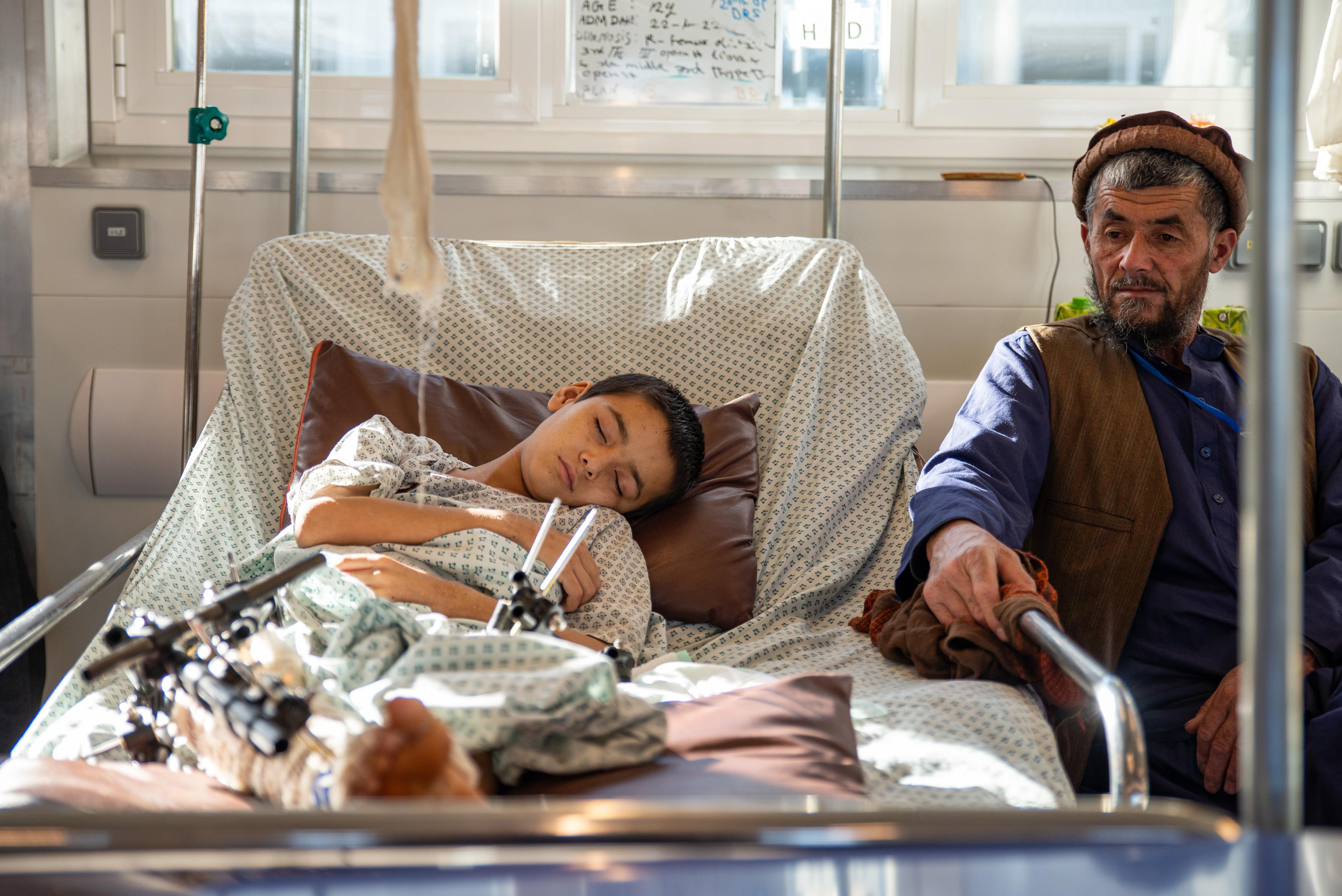 Edalat sits by his son’s bed in the male inpatient department at the Kunduz Trauma Centre in Afghanistan. 