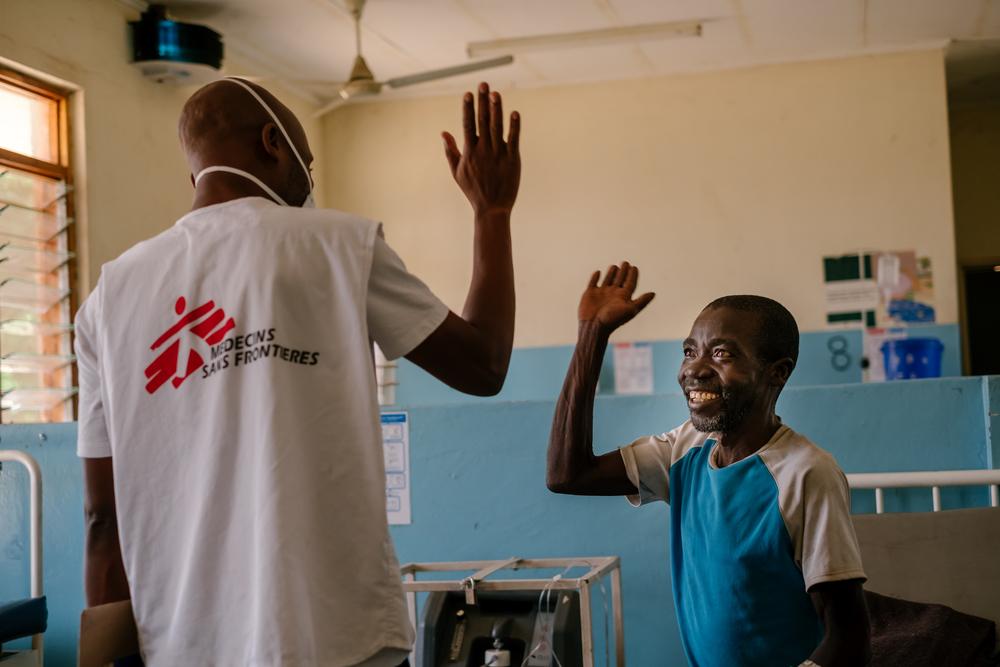 Moses Luhanga, MSF Information Education and Communication Manager giving Manfred in TB ward at Nsanje District Hospital a high five. 