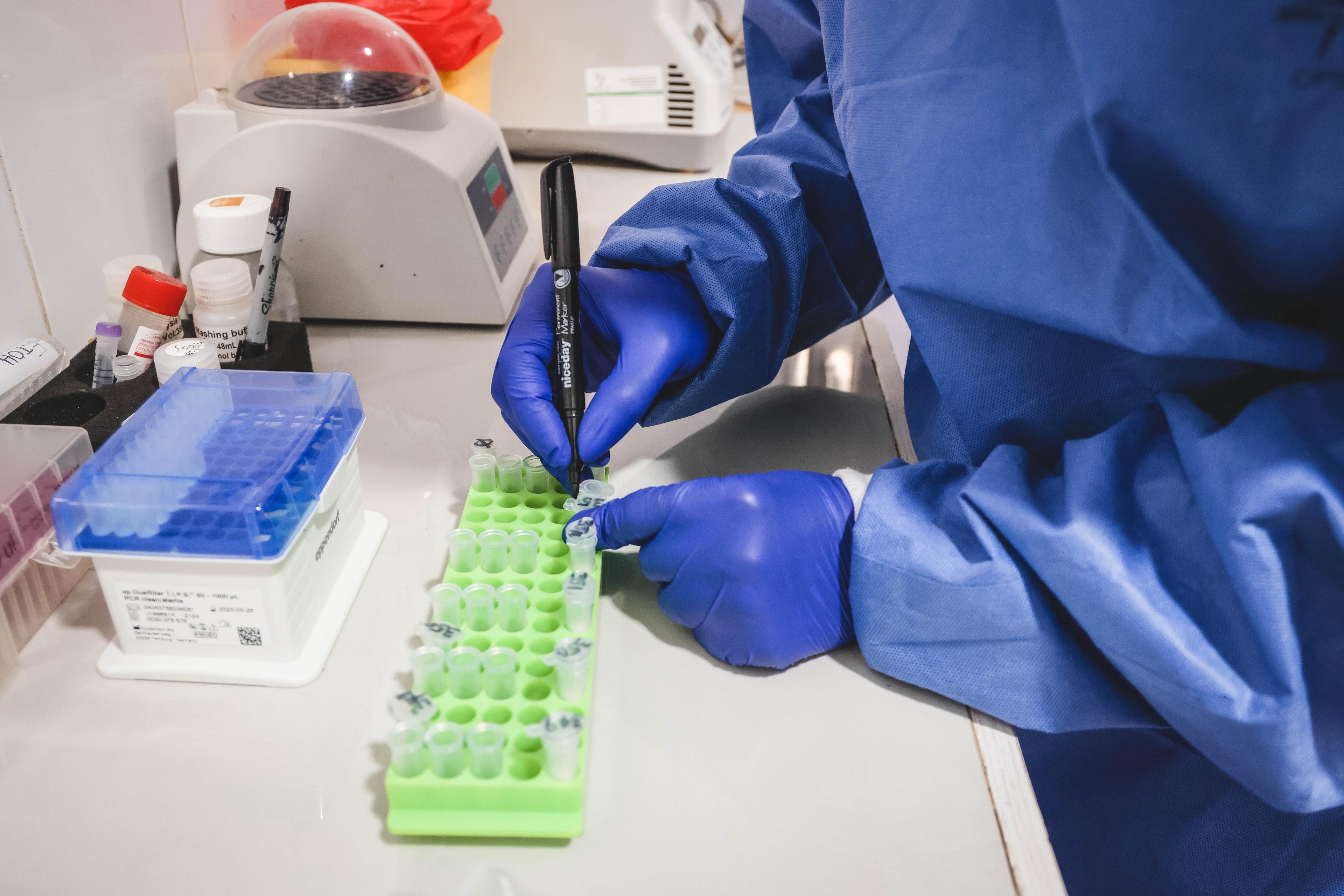 MSF’s Chime Chinda, labelling Lassa fever sample containers for laboratory analysis.