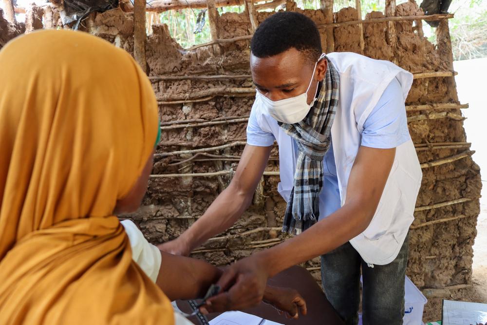 Une infirmière porte un masque réutilisable lors de la consultation d'un patient dans le nord du Mozambique, où les maladies sensibles au climat, telles que celles propagées par les moustiques, sont courantes. © Lourino Pelembe/MSF