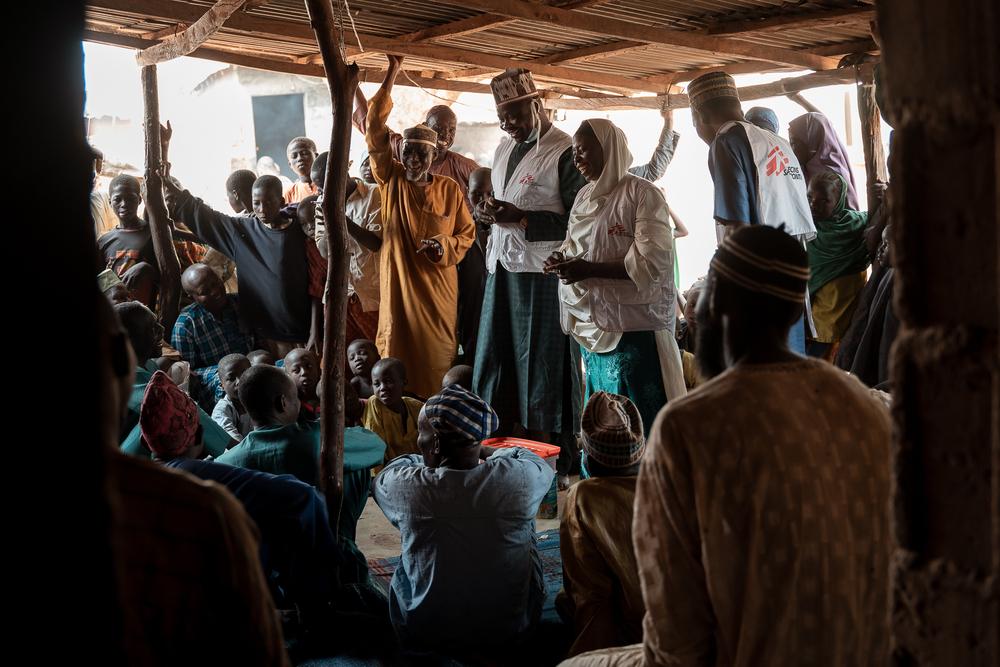 Maryam Muhammad and the MSF health promotion team conduct a Tom Brown sensitization session for men in Kebbi. Convincing men to support the approach is key as the mostly are the one supplying the family. For cultural reasons, MSF organizes separated sessions for men and women. ©Georg Gassauer/MSF  