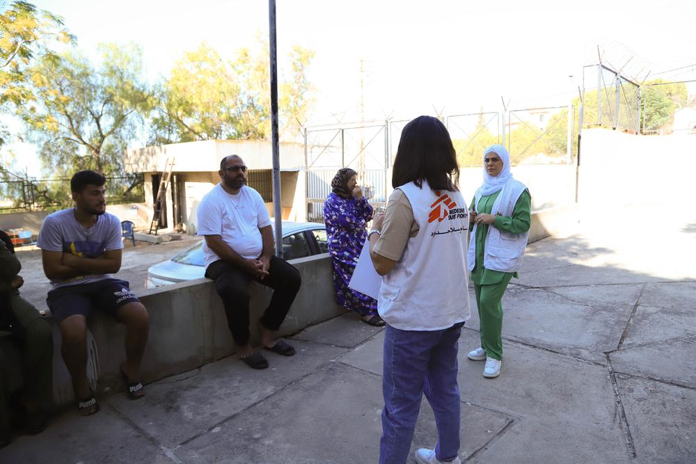 Un conseiller en santé mentale de MSF explique aux patients les services médicaux et les médicaments disponibles proposés par la clinique mobile.