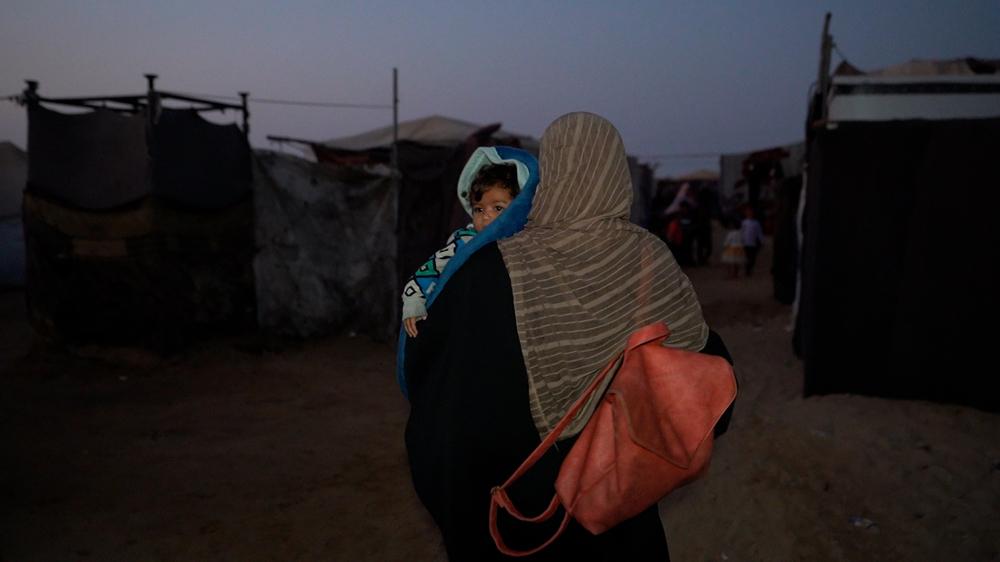 Yasmin, 28, carries her seven-month-old son, Ibrahim, to the hospital, just two days after being discharged from it. 