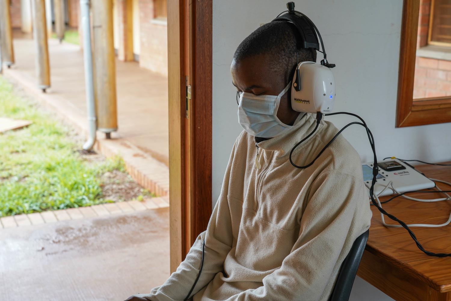 The side effects of TB medication can induce deafness. Here, a patient has a hearing test in the MSF-built TB ward at Nhlangano health centre, Eswatini, June 2018. 