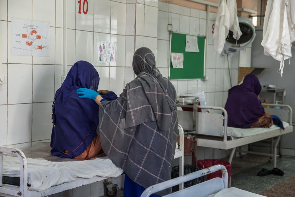 An MSF midwife accompanies a pregnant woman in the labor room at the MSF Khost maternity hospital. October 2021