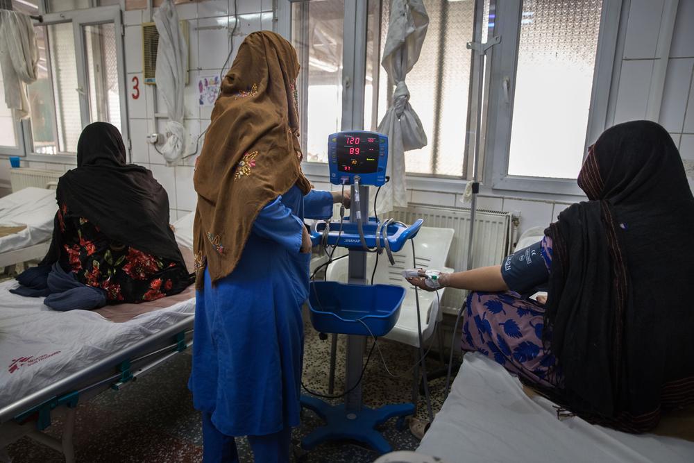 An MSF midwife accompanies a pregnant woman in the labor room of the MSF maternity ward in Khost, Afghanistan.