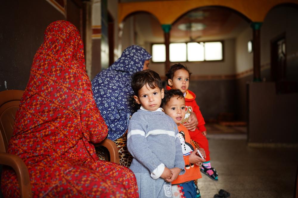 An MSF patient, a four-year-old Nabeel, stand next to his family in Khan Younis, Gaza. Nabeel accidently burned his back while his grandmother Sana was baking bread. 