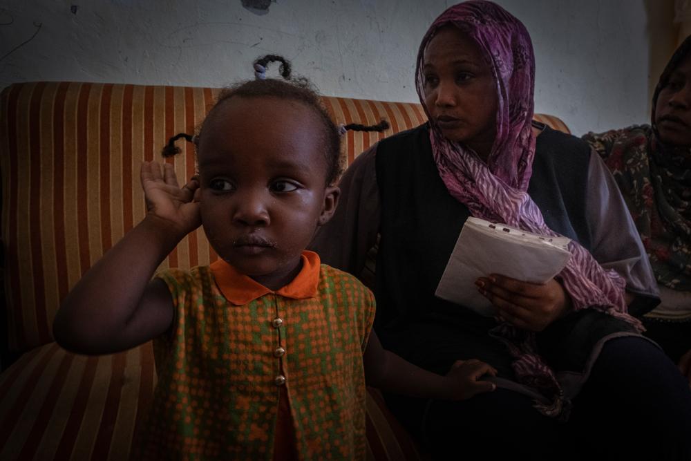 Nadia* and one of her two daughters in the house in Gargaresh, Libya, where they live. 