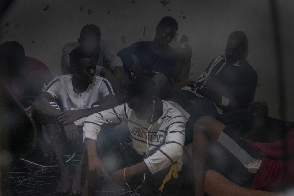 A group of migrants and refugees gathered in a shared dwelling in Saraj, Libya. August 2021.  