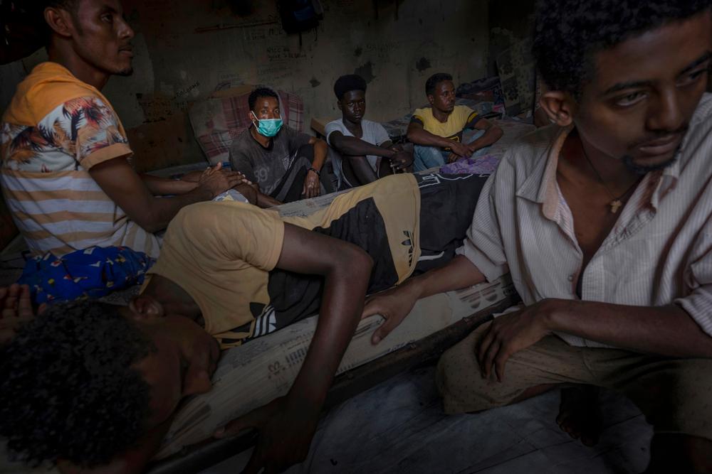 A group of migrants and refugees gathered together in a shared dwelling in Libya in August 2021. 