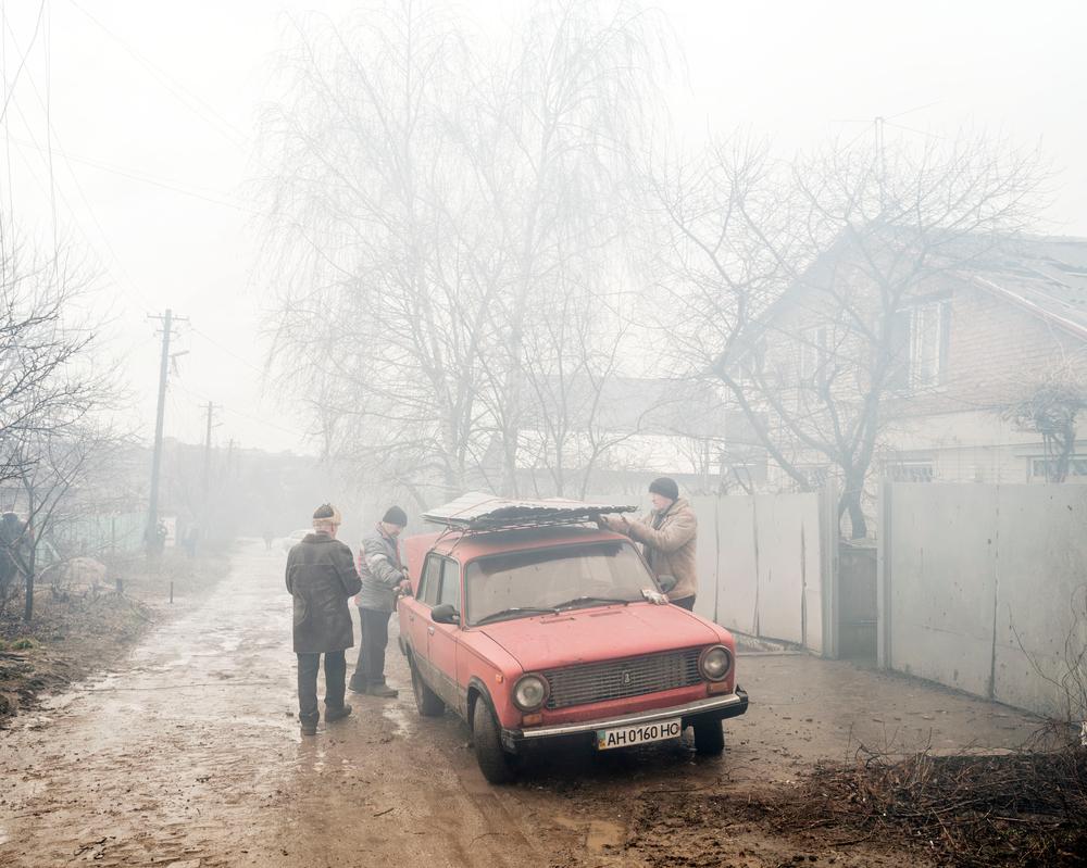 UKRAINE. Mariupol. 24 February 2022. Civilians whose homes were hit by a rocket leave the area. 