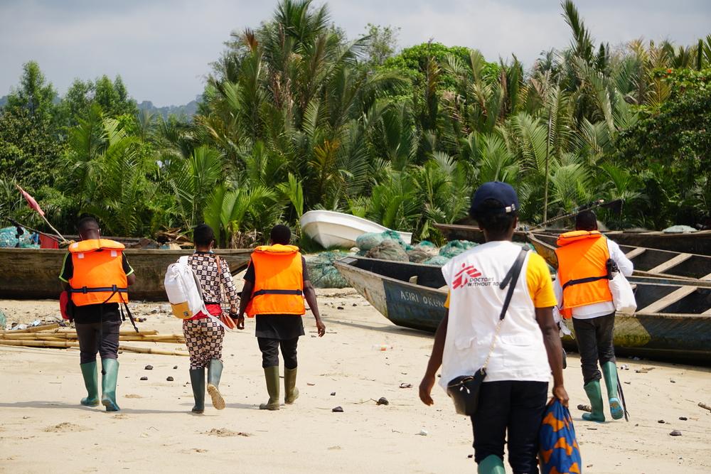 An MSF team at the entrance to the village of Enyenge in south-west Cameroon  