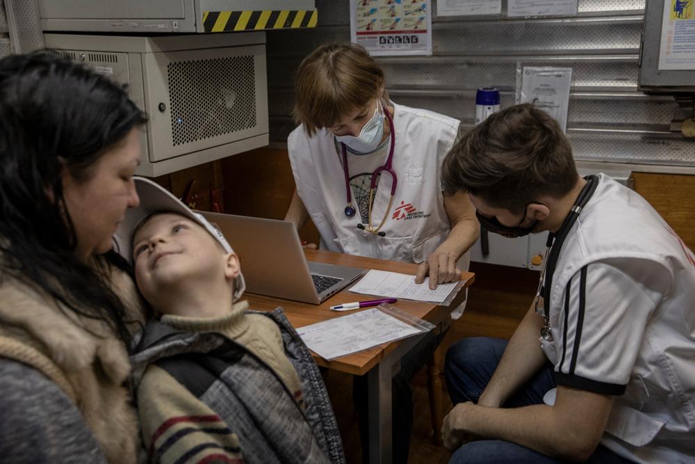 Elena, 35, and her son Kirill, 6, are examined by Kelly and Kirill in Kharkiv, Ukraine, on 11 April 2022. 