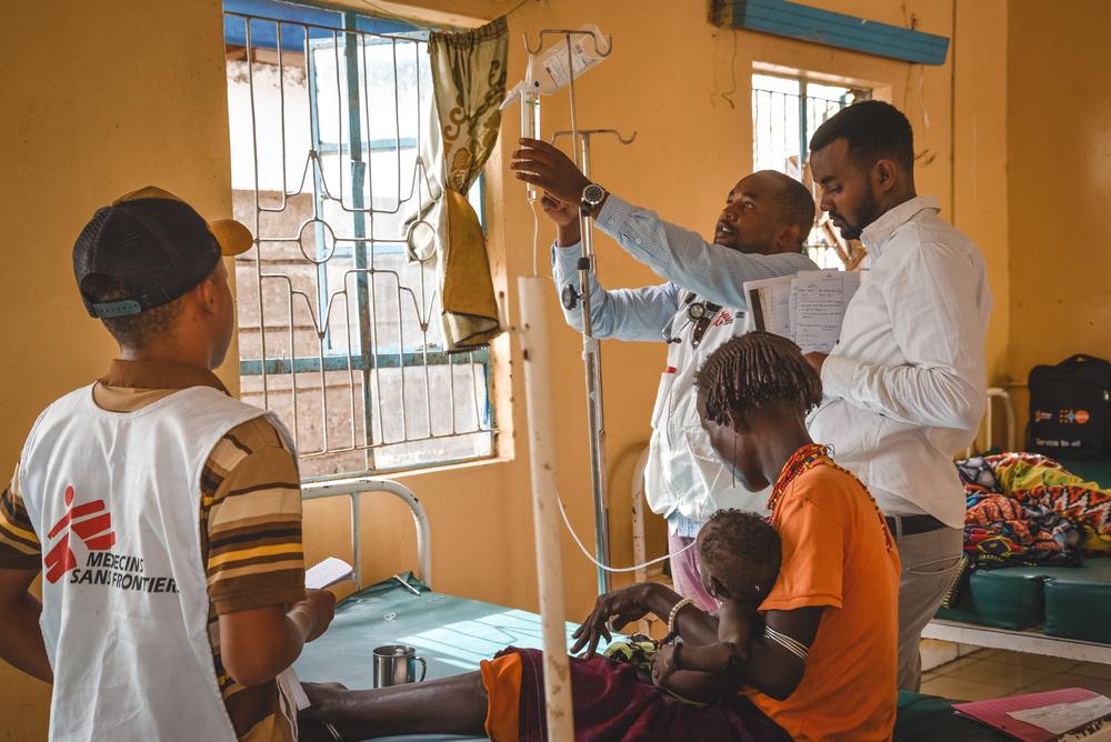 MSF clinician, nurse and nutritionist attend to nine-month old Egura Arbollo during a ward round in Illeret Health Center. 