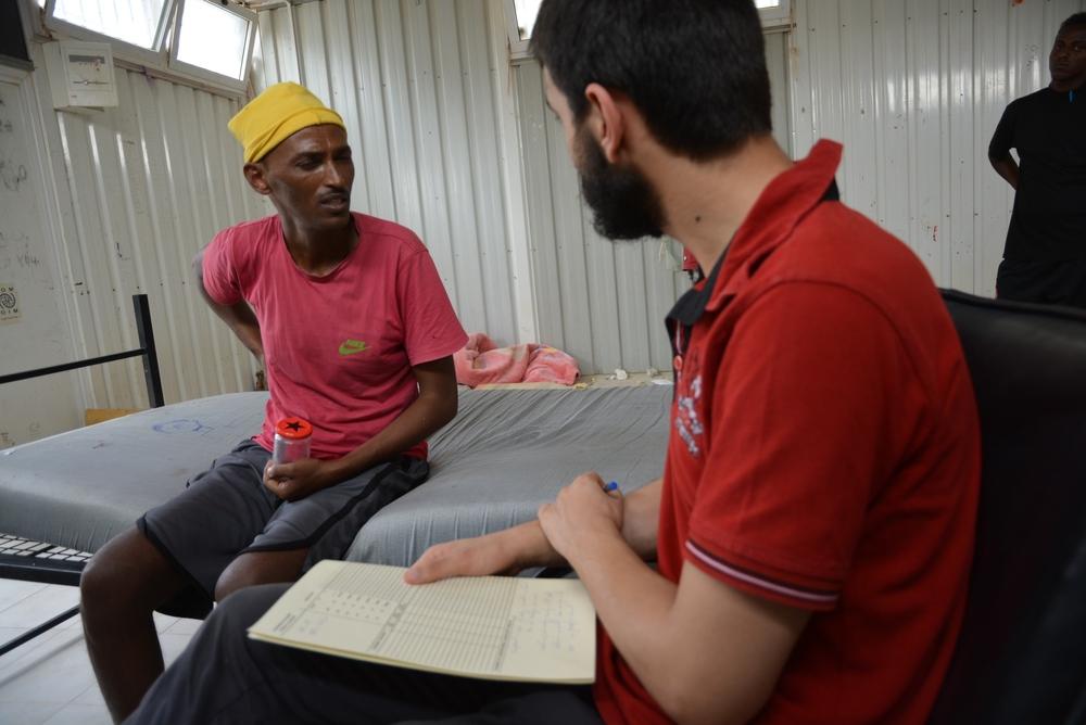 John during a medical consultation with an MSF doctor at the Gharyan al-Hamra detention centre. He was suffering from tuberculosis and had been locked in a container for months without access to treatment. Libya. 2019.  