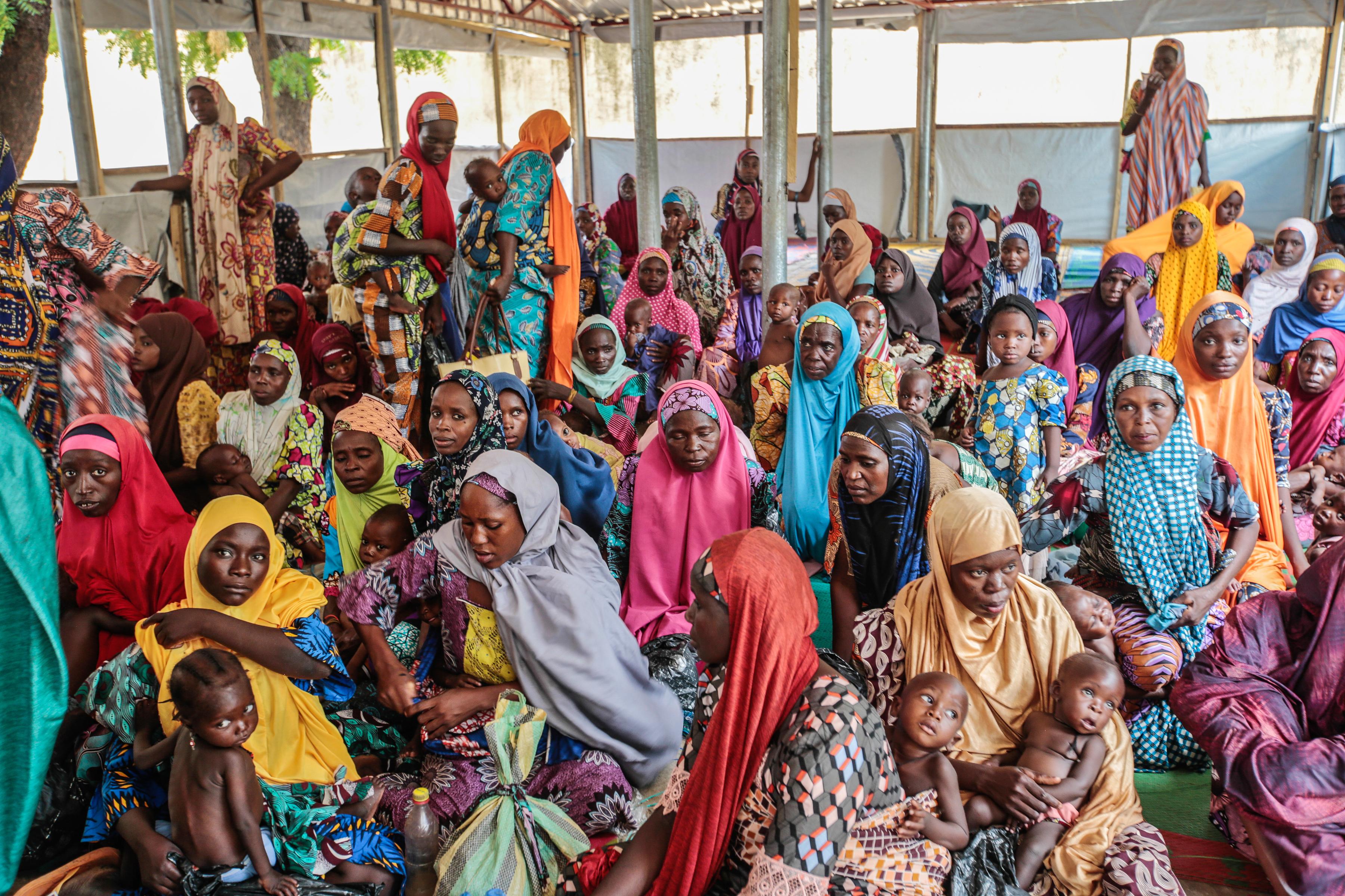 Mothers wait with their children to see the medical team in MSF’s ambulatory therapeutic feeding centre in Katsina town. Katsina State, Nigeria, June 2022.  