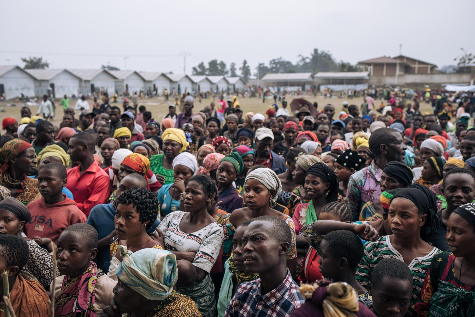 Des centaines de personnes déplacées par le conflit attendent une distribution de kits ménagers (pots, couvertures, savon, etc.) sur le site informel pour déplacés internes du stade Rugabo le 18 juillet 2022, dans la province du Nord-Kiv  