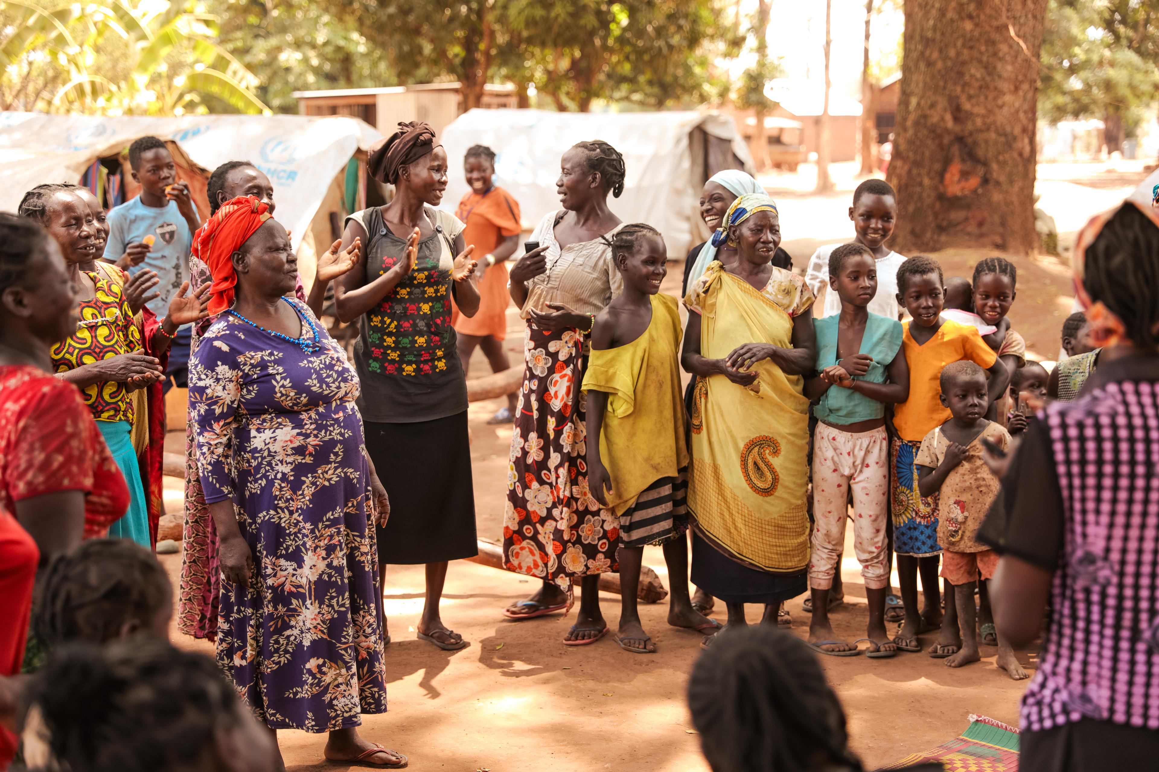 Participants in the mental health group sing and dance, as a way to relieve stress and find some joy despite the crisis they have all endured.