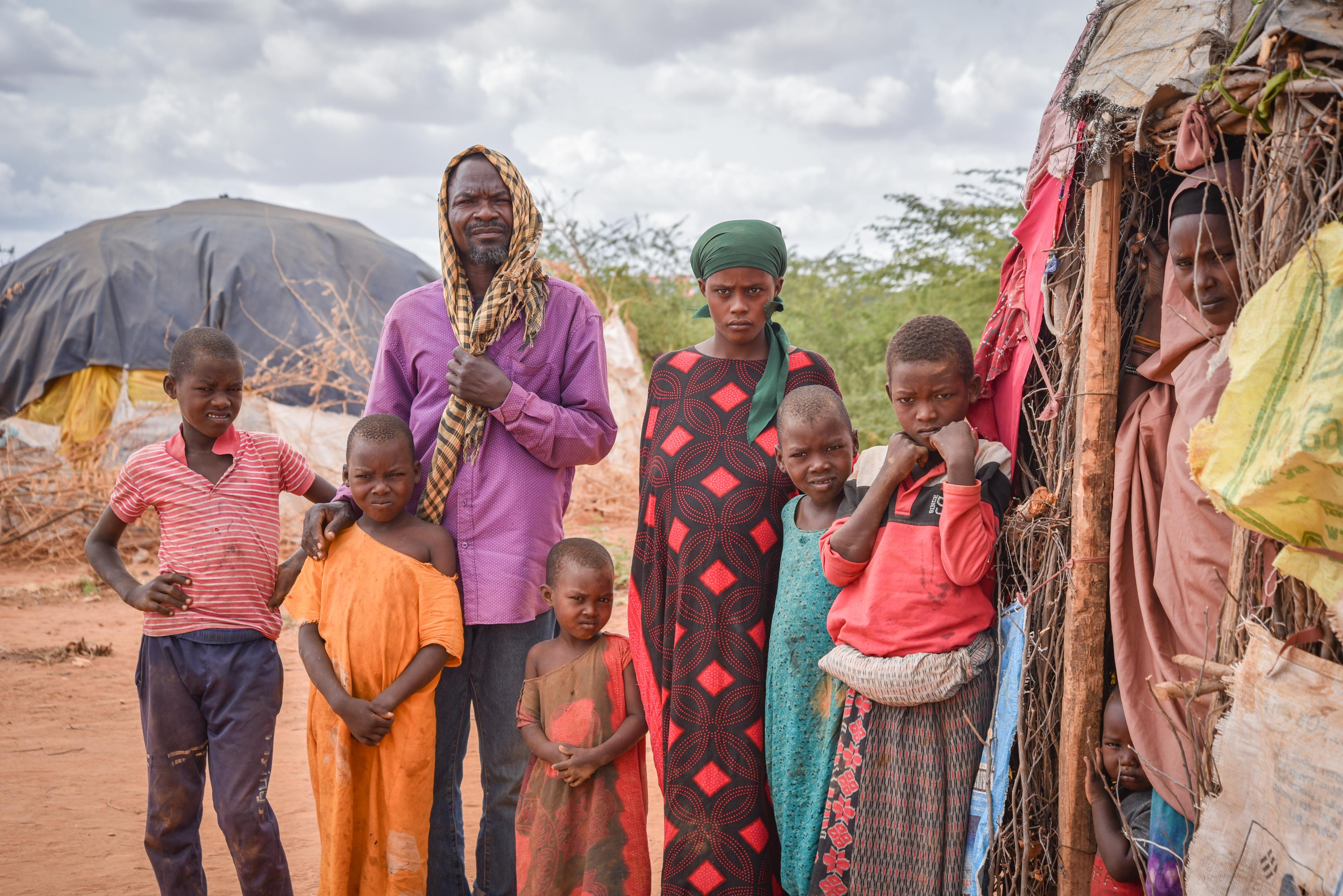 Borow Ali Khamis, 50, stands in front of their makeshift shelter with his family in Dagahaley refugee camp. He used to be a farmer and cattle herder in Somalia, but he lost everything because of the long drought. 