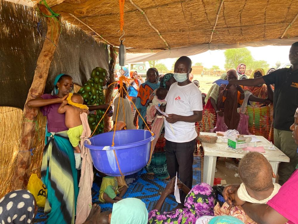 Bertin, infirmière MSF dans la province de Sila, prend le poids et les paramètres vitaux du petit Bachir, qui a été amené à la consultation par sa mère, avant de lui faire passer des tests pour détecter la malnutrition. 