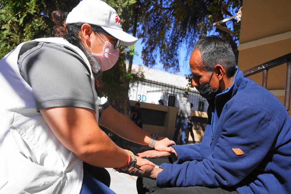 A nurse assists a Honduran man outside a migrant shelter in Piedras Negras, Coahuila state. 