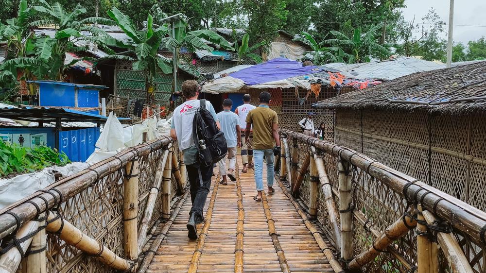 MSF staff walking through the Bangladesh refugee camps. 