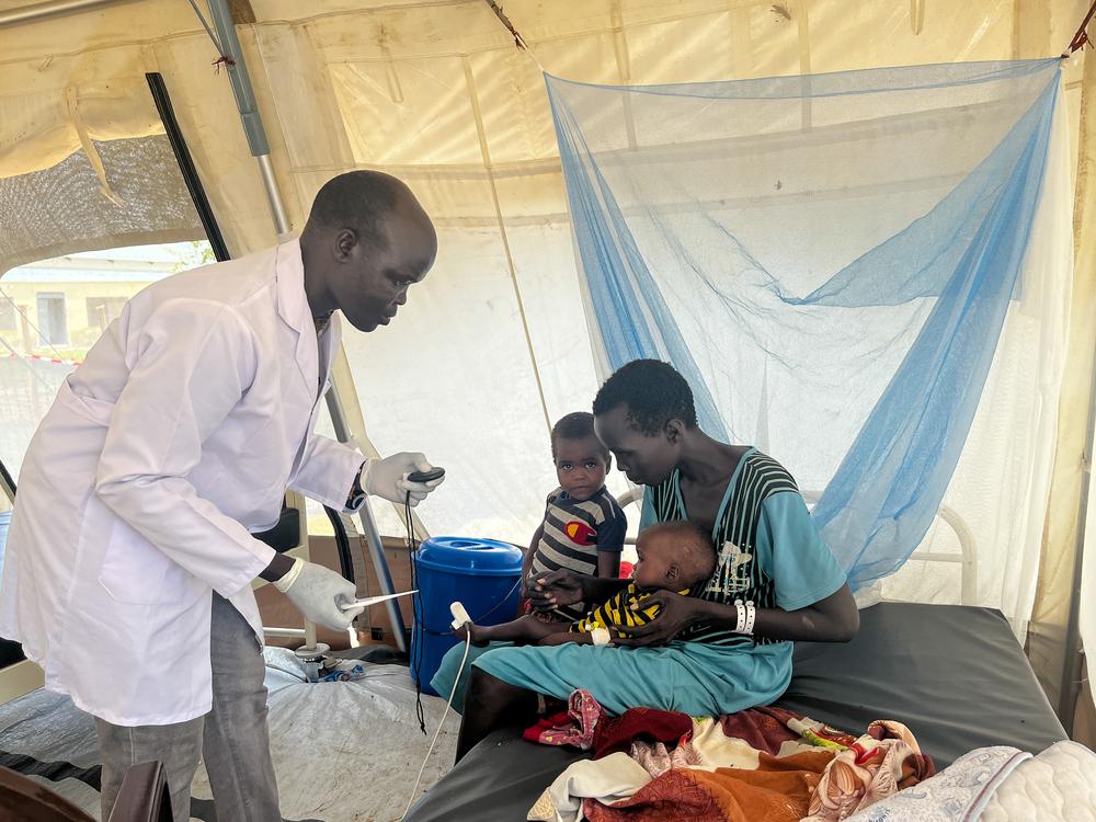 MSF nurse Isaac Dak examines Nyakoang Bigoah, a 7-month-old boy admitted to the MSF-supported inpatient therapeutic feeding centre at Renk Civil Hospital in Upper Nile State. 