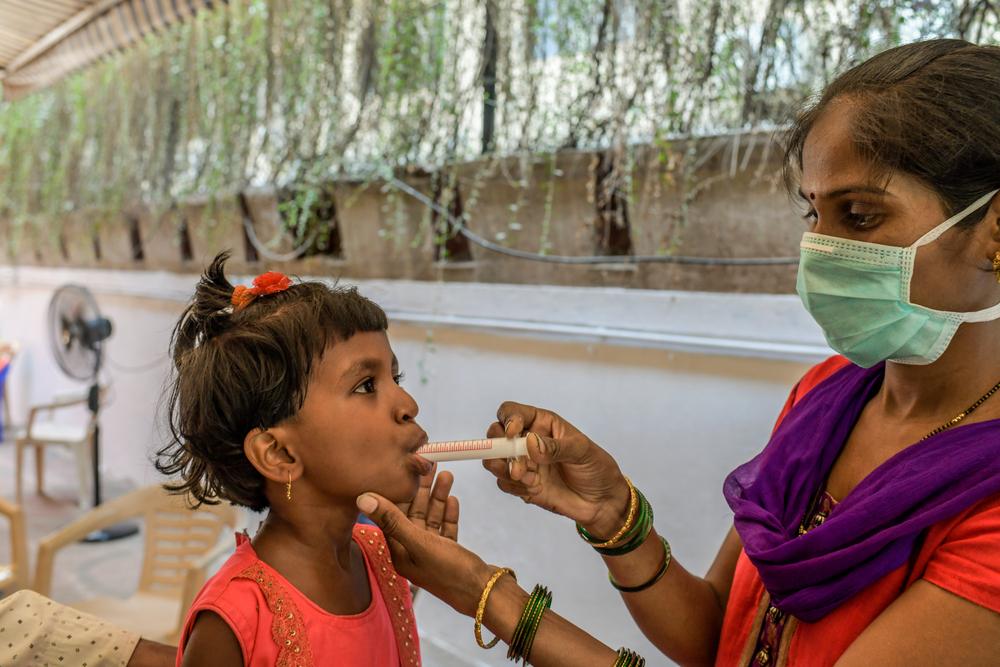 Mother of six-year-old MDR TB girl child administering manipulated form of DRTB drugs. March 2021 