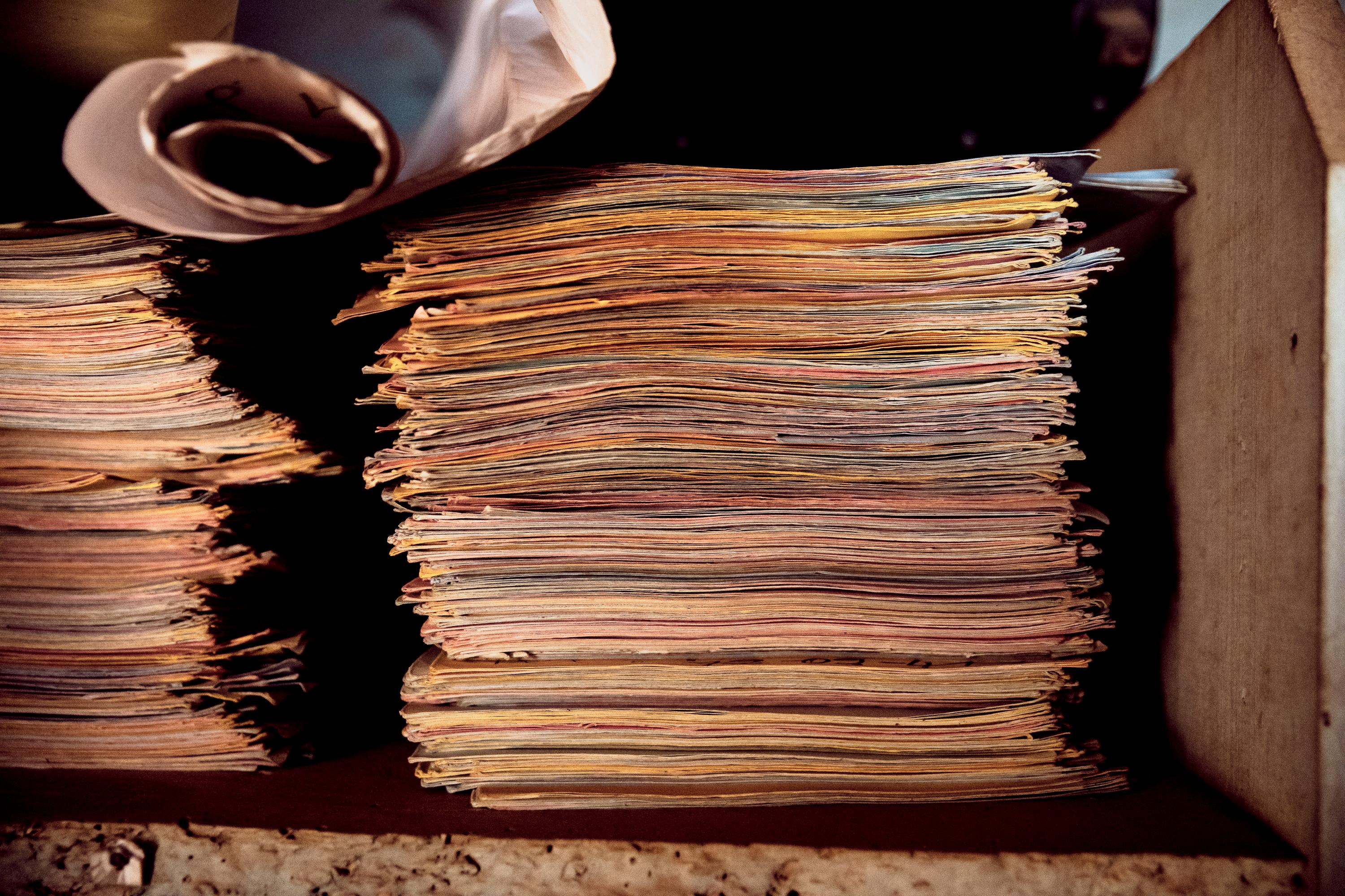 Files of survivors of violence collected by Étienne Oumba, neighbourhood chief and the founder and president of the AVUC, in his office in Bangui, CAR. Tongolo. December 2020. 
