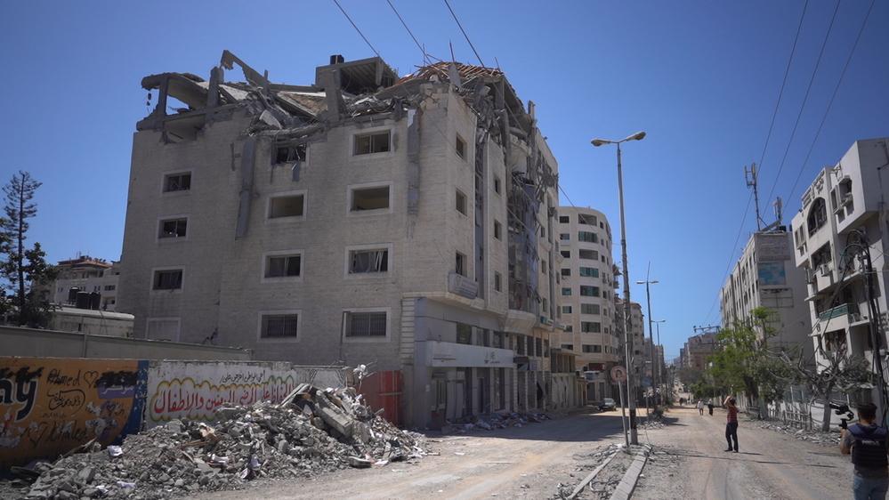 Palestinian walks amidst the rubble in the Gaza city. May 2022 