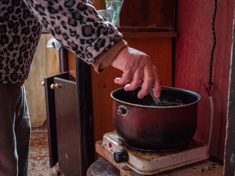 Fawziyya Al-Sahili stiring her vegetable stew. 