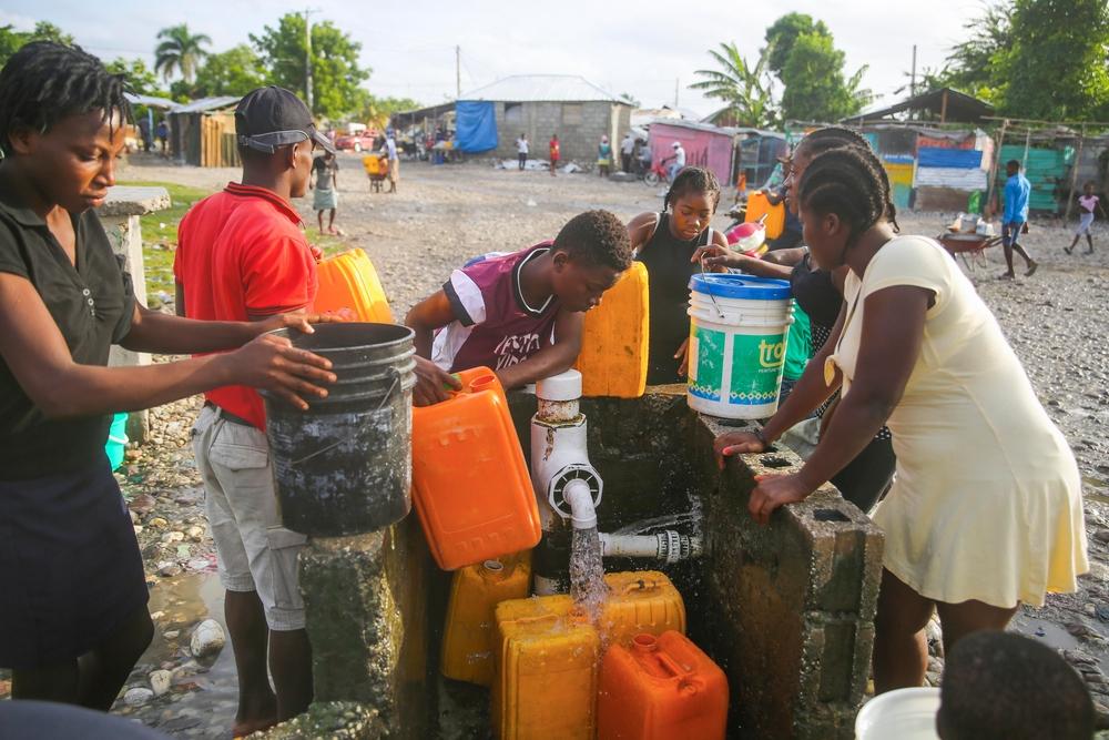 People gathering water at one of the water points at Croix Marti, an area of Les Cayes city 