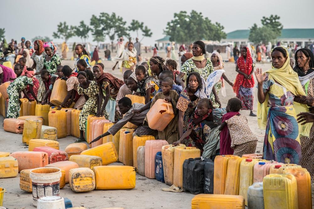 very morning the camp residents rush to fill their water buckets. Access to water is a major problem for the displaced. Nigeria. 