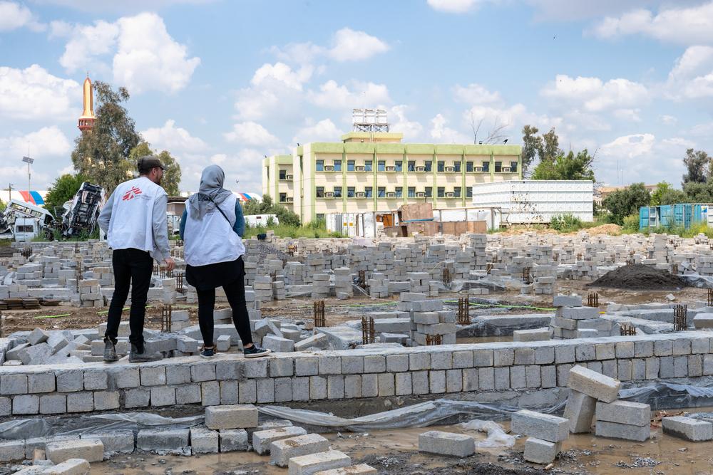 Two MSF staffs look at the progress of the construction work. MSF is building a new facility for the Al Shifaa’ hospital in Mosul. 