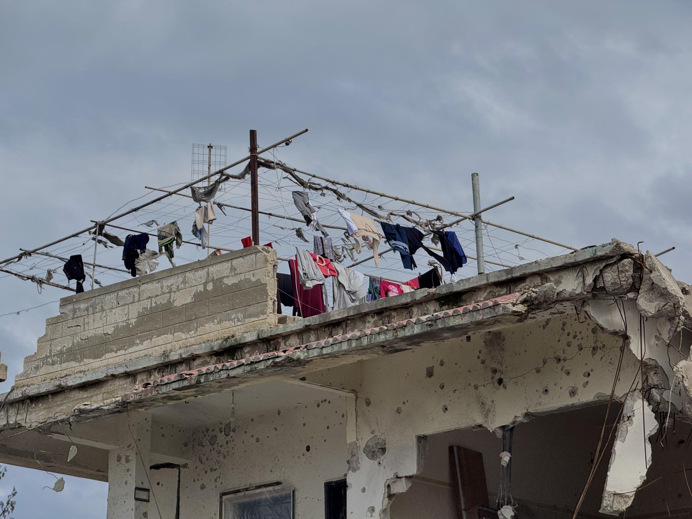 Une famille palestinienne étend son linge sur sa maison endommagée dans la ville de Jabalya, au nord de la bande de Gaza.
