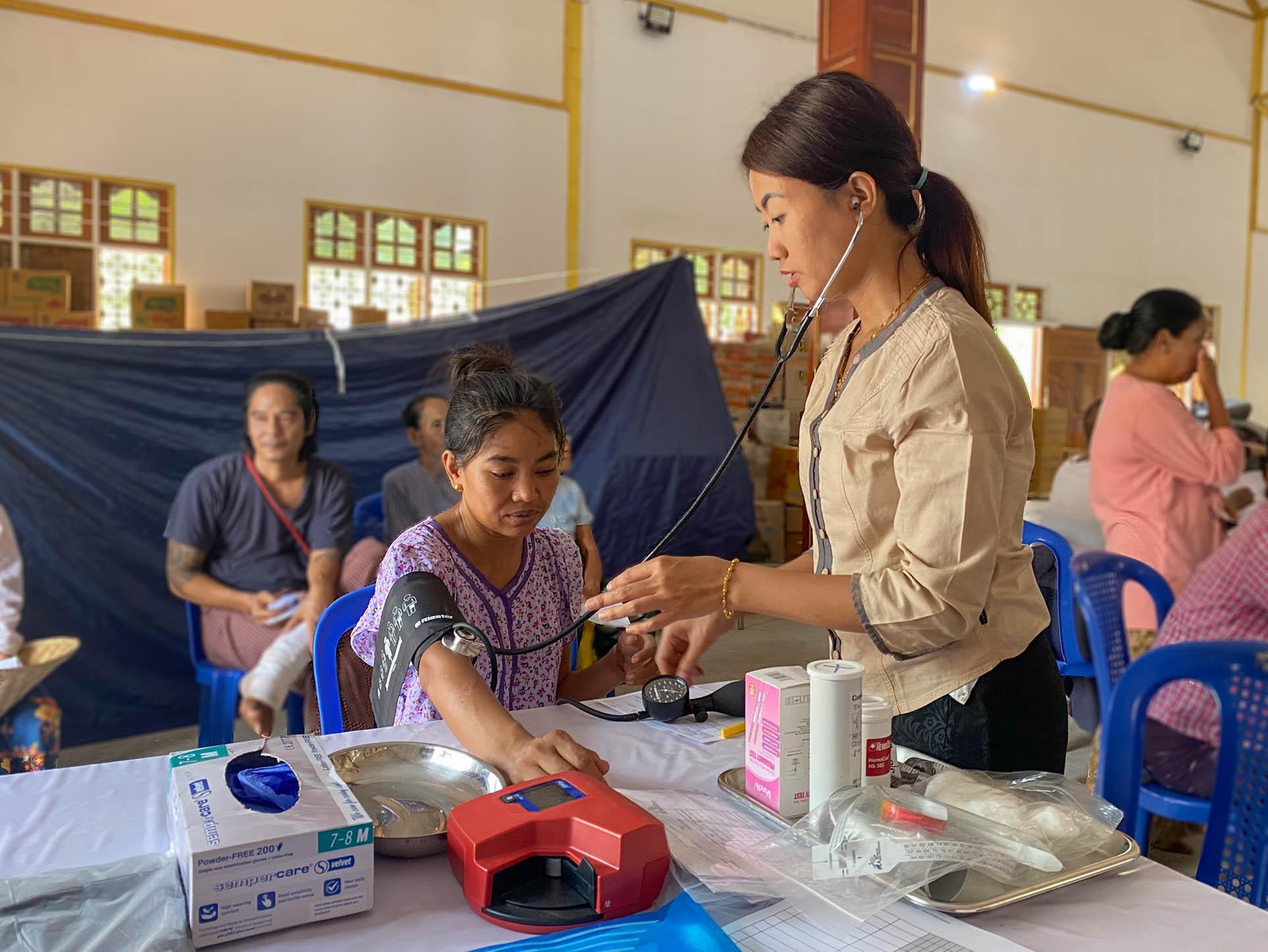 La sage-femme May Phyoe Thu (38 ans) vérifie la tension artérielle de Win Win.