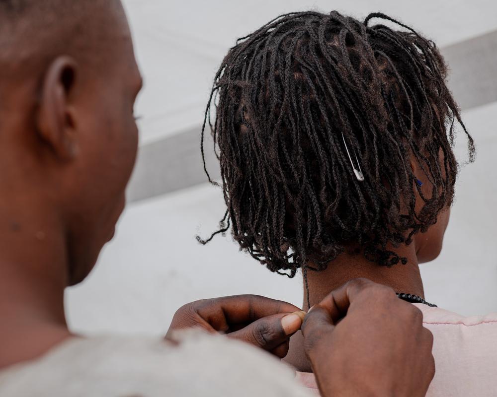 Fanan, le fils de Seember, tresse les cheveux de sa mère. © Kasia Strek/MSF