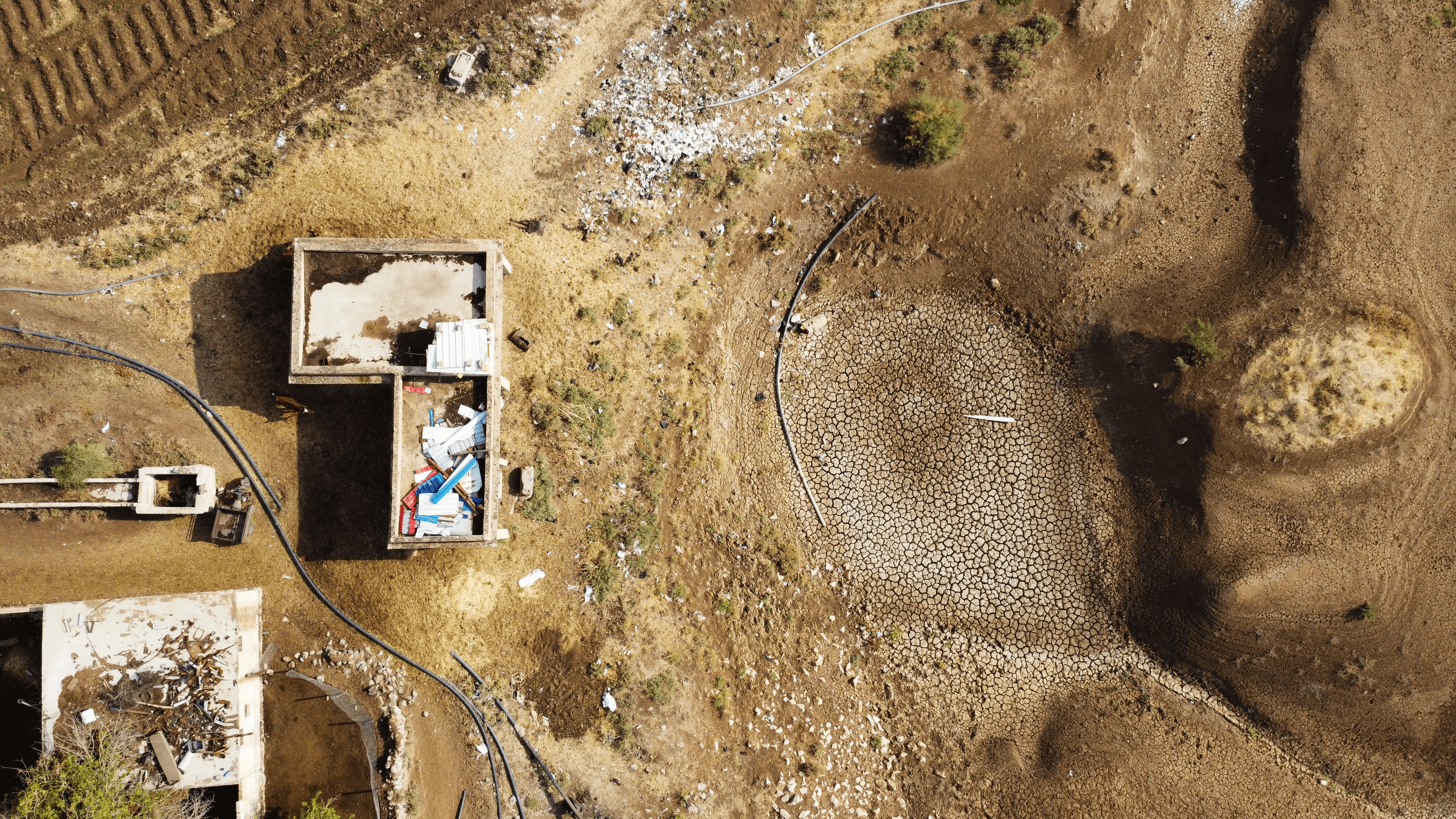 Une photo aérienne prise en haute altitude montre les abords du village de Tal al-Sakhr, situé sur les rives du fleuve Khabour. Les fissures dans le lit du fleuve sont dues à la sécheresse, conséquence d'une pénurie d'eau, dans la campagne d'Hassaké, au nord-est de la Syrie