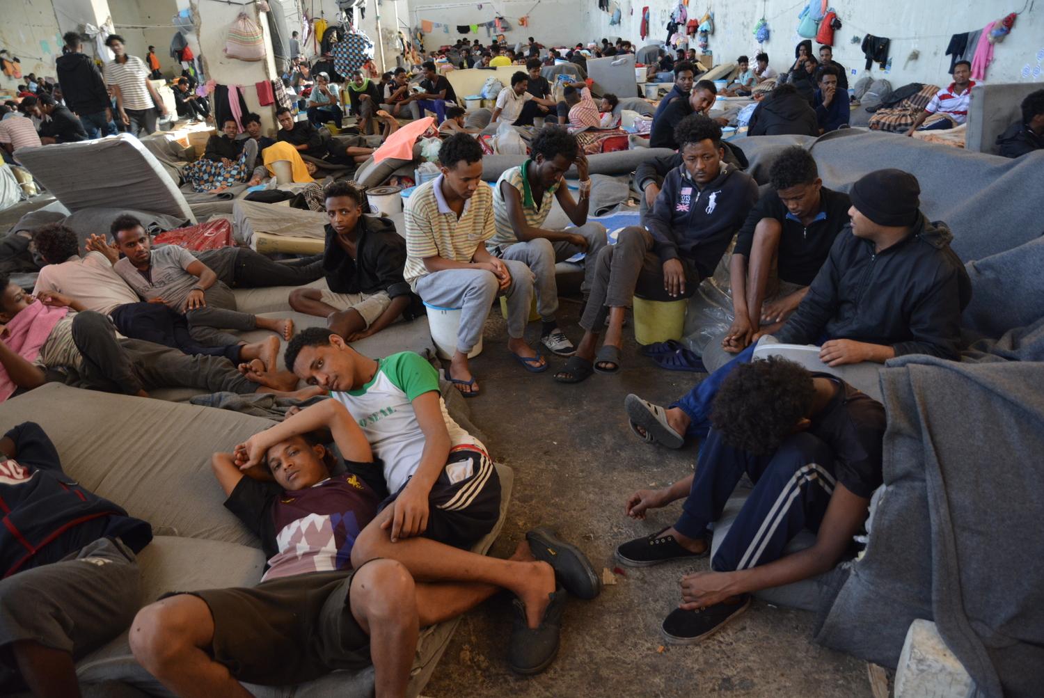 Some of the 700 refugees detained in the main warehouse of Zintan detention centre. In June 2019, the detainees were distributed in other buildings within the compound. Libya, July 2019. 
