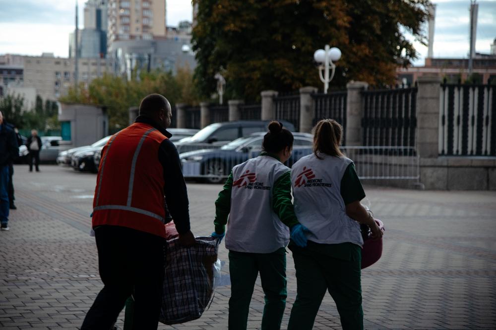 MSF staff members bring belongings of the patients evacuated from Kharkiv city, eastern Ukraine, to a bus that will drive them to hospitals in Kyiv. 