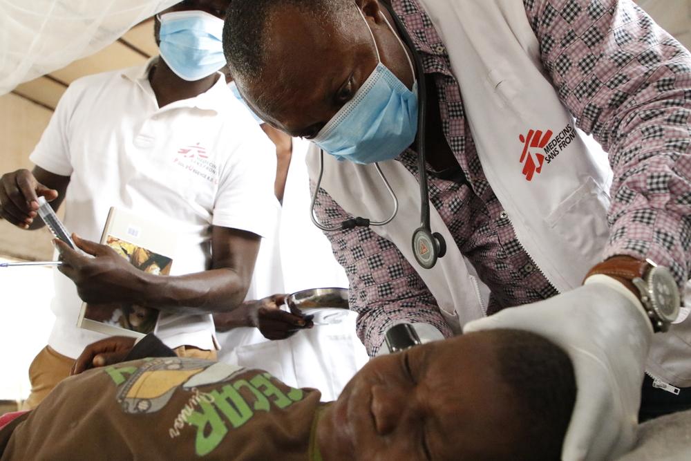 Théophile, médecin de l'équipe d'urgence de MSF, examine un enfant atteint de rougeole à l'hôpital général de référence de Bosobolo en RDC. 