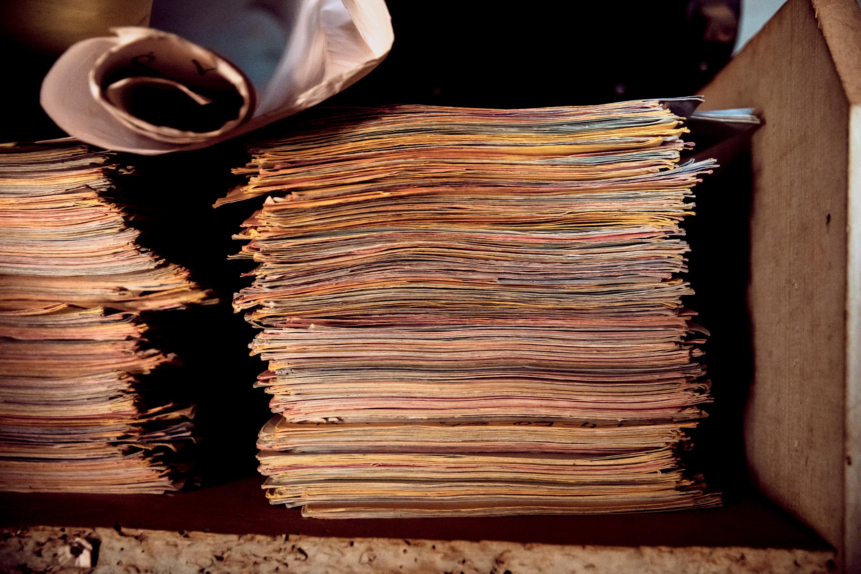 Files of survivors of violence collected by Étienne Oumba, neighbourhood chief and the founder and president of the AVUC, in his office in Bangui, CAR. Tongolo. December 2020. 