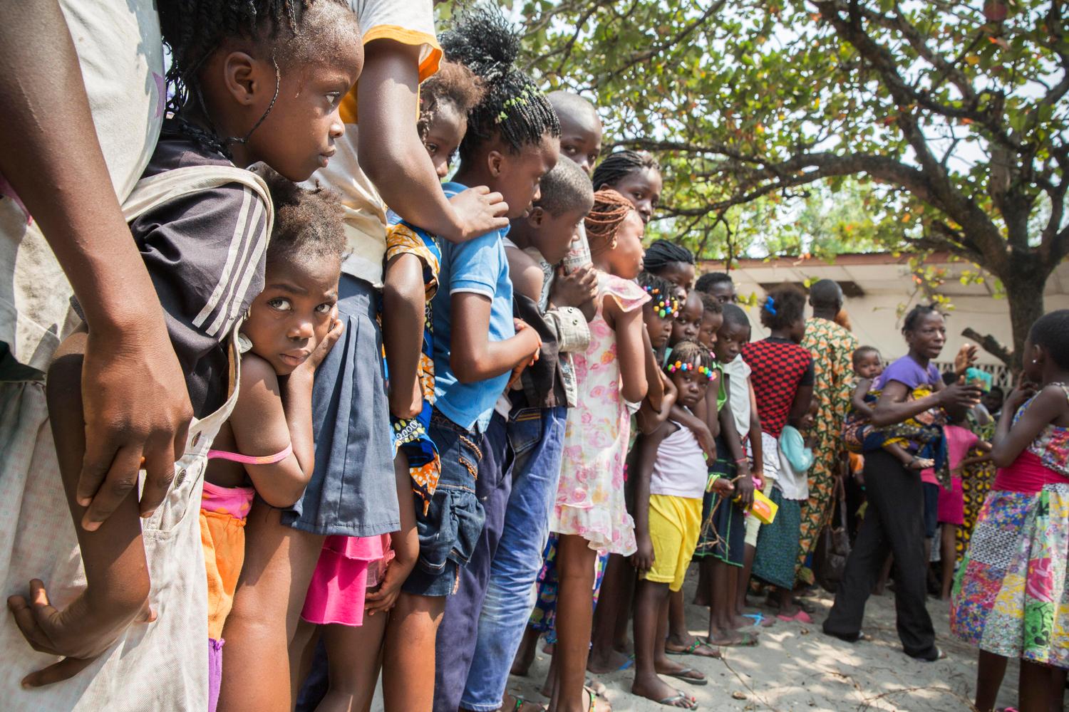 People queue to be vaccinated outside a school in the Zone de Santé Kikimi in Kinshasa. After an outbreak of yellow fever Medecins Sans Frontieres (MSF) is running a massive vaccination campaign in Kinshasa. 