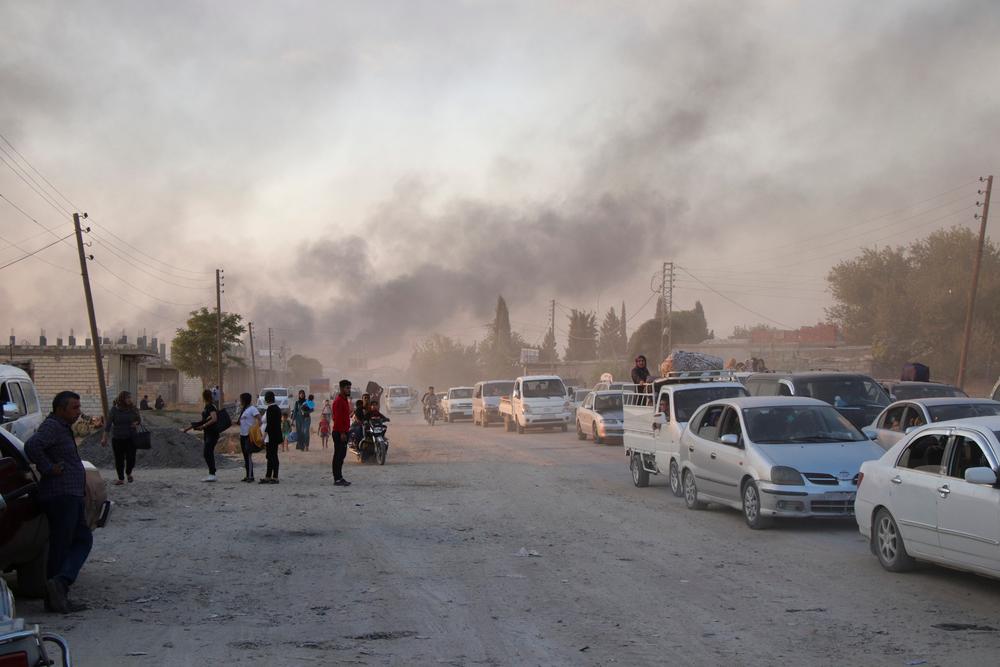 Syrians flee shelling by Turkish forces in Ras Al-Ain, northeast Syria, 9 October 2019. 