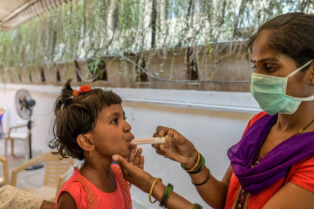 Mother of six-year-old MDR TB girl child administering manipulated form of DRTB drugs. March 2021