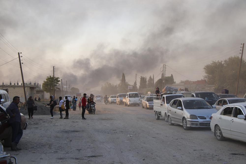 Syrians flee shelling by Turkish forces in Ras Al-Ain, northeast Syria, 9 October 2019.